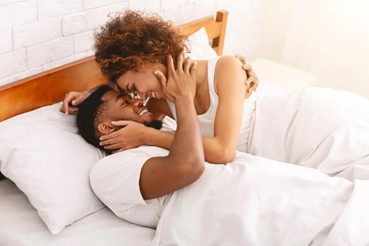 couple of lovers relaxing in bed at home, enjoying each other