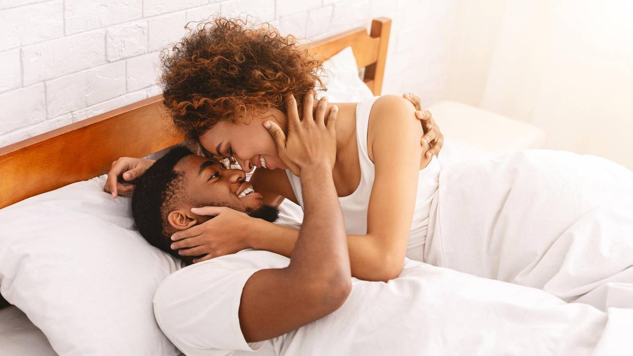couple of lovers relaxing in bed at home, enjoying each other