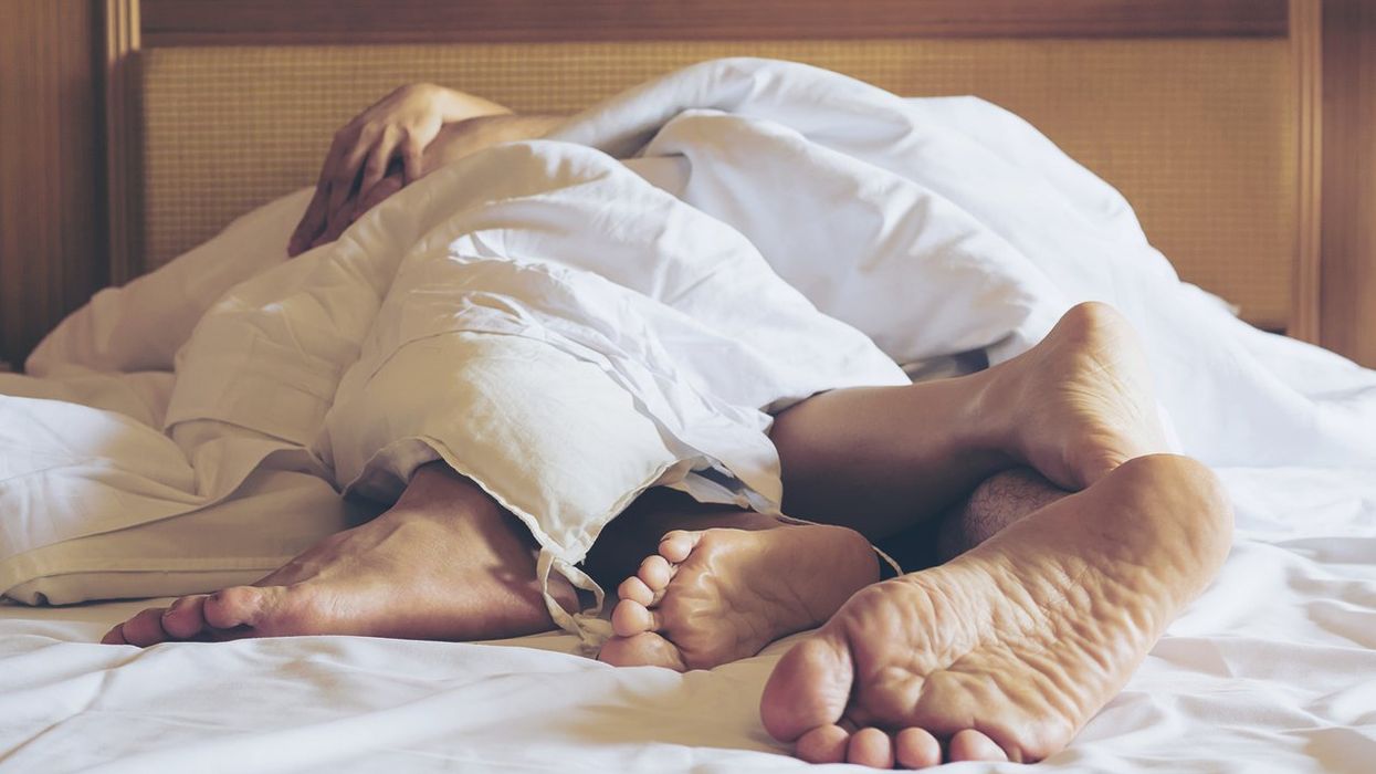 Couple Sleeping On Bed At Home