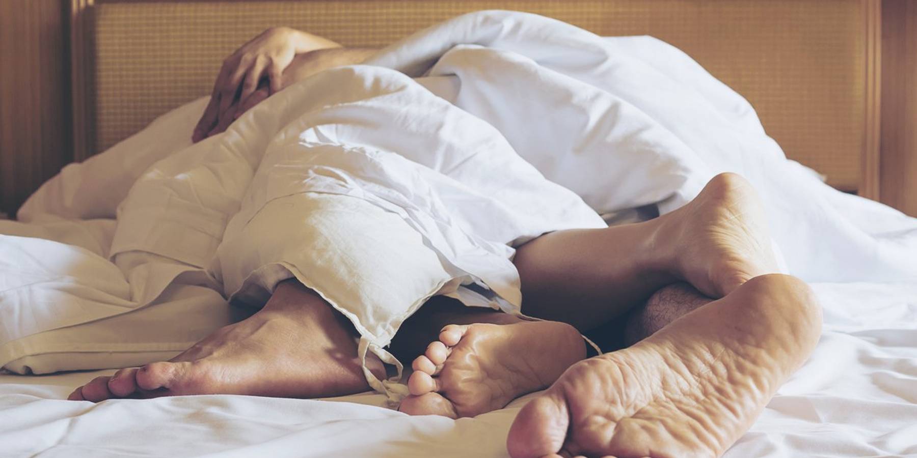 Couple Sleeping On Bed At Home