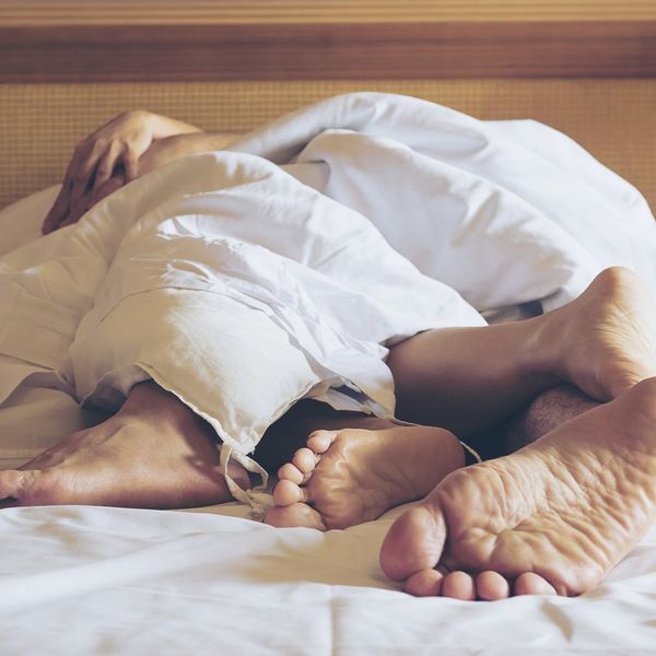 Couple Sleeping On Bed At Home