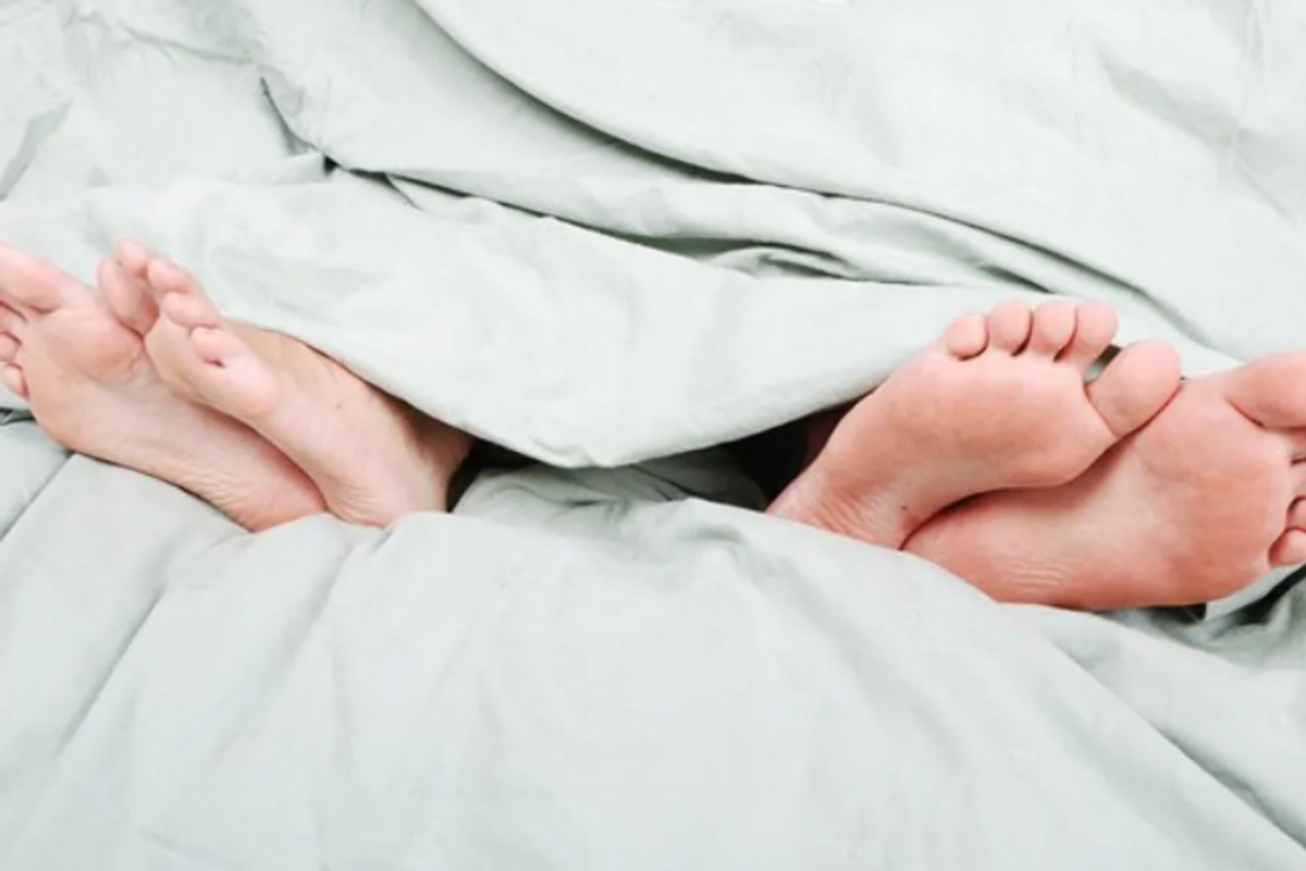 couples legs in a bed