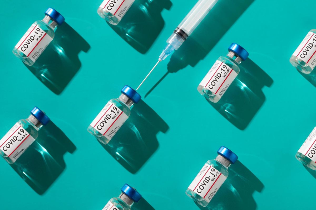 Covid 19 coronavirus vaccine vials with syringe