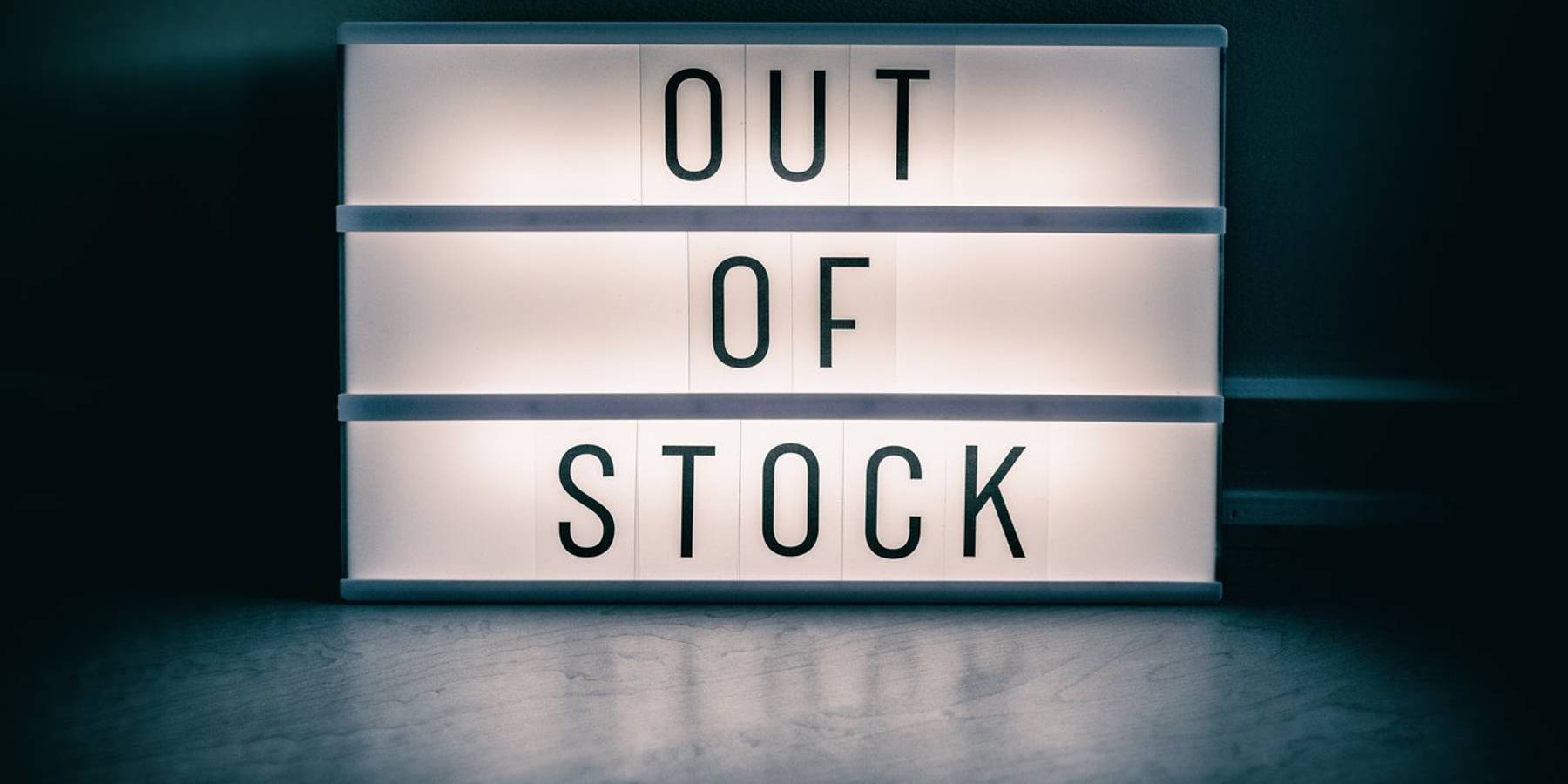 Covid-19 OUT OF STOCK store lightbox sign showing text message for shortage of PPE medical supplie