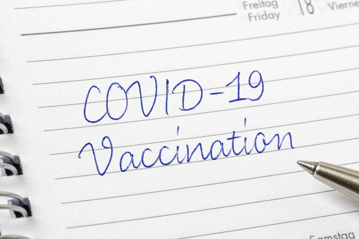COVID-19 Vaccination written on a calendar page
