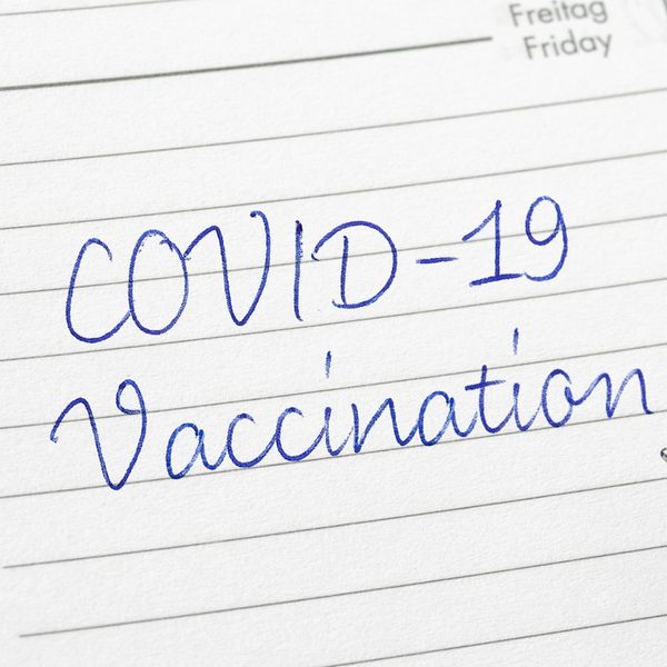 COVID-19 Vaccination written on a calendar page