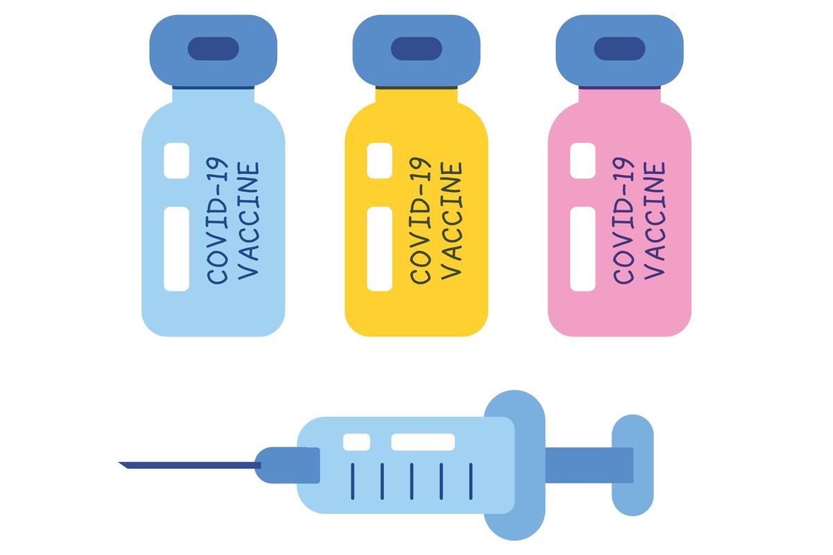 COVID-19 vaccine vial bottles and medical syringe