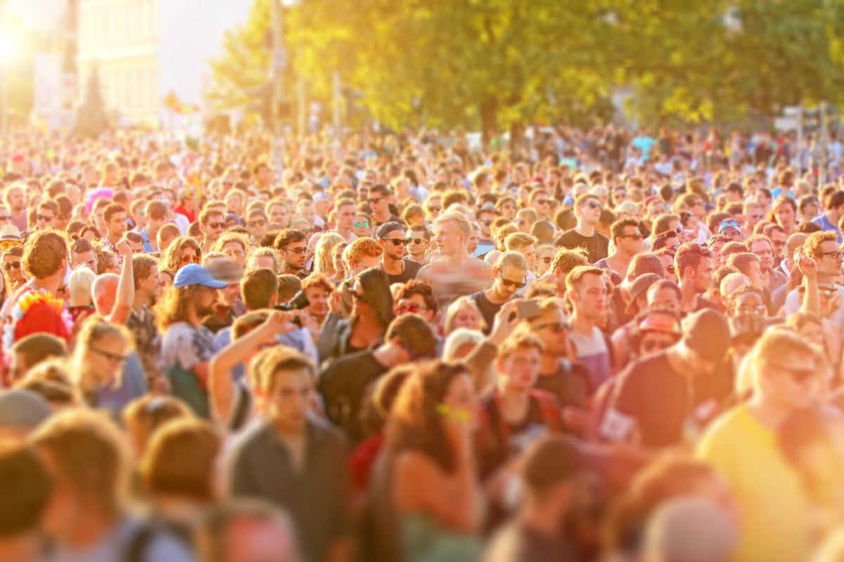 Crowd of young people having fun at music street festival
