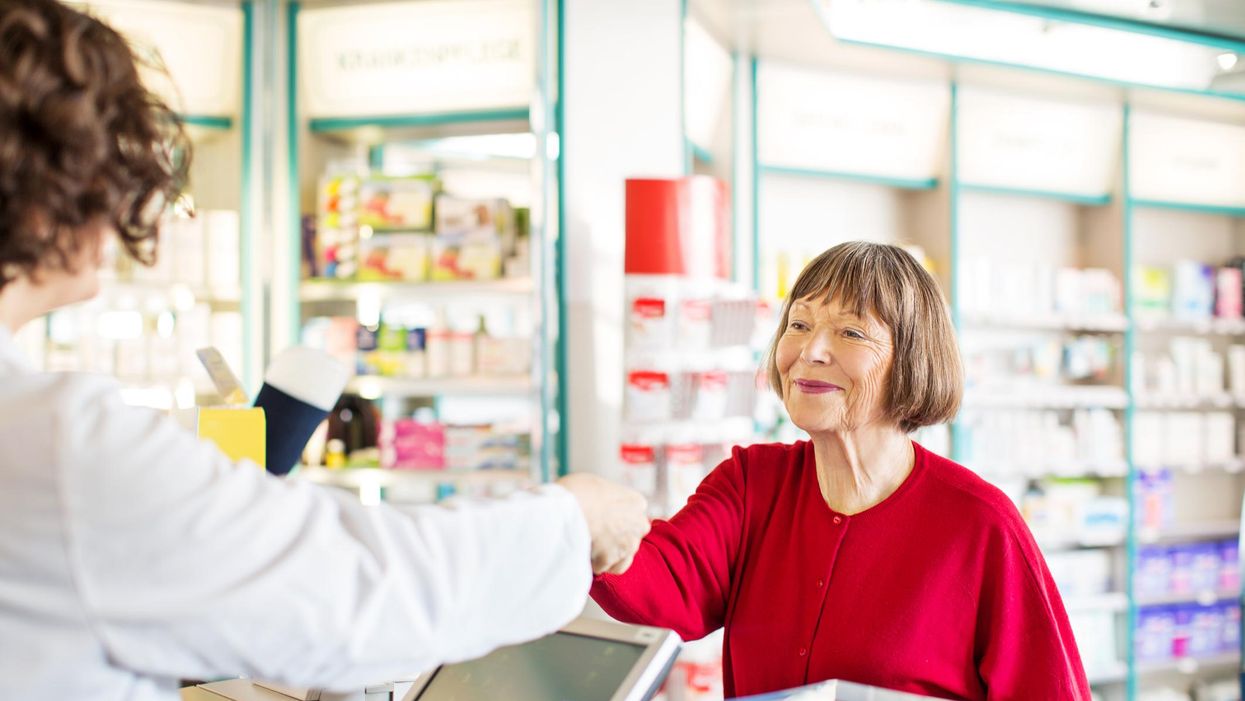 Customer receiving medication from pharmacist