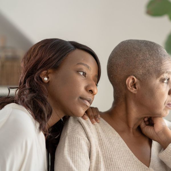 daughter sitting with mom who is battling cancer