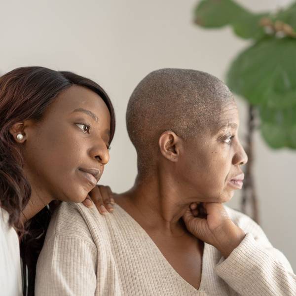 daughter sitting with mom who is battling cancer