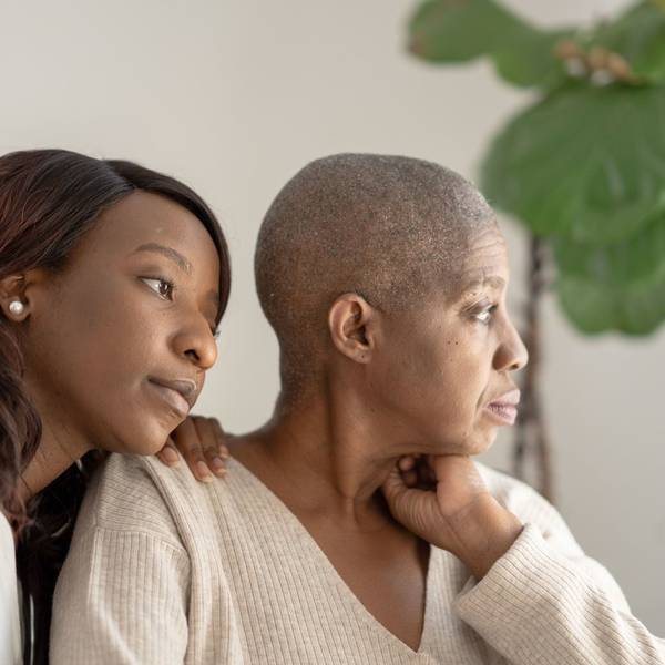 daughter sitting with mom who is battling cancer