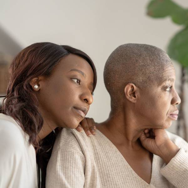 daughter sitting with mom who is battling cancer
