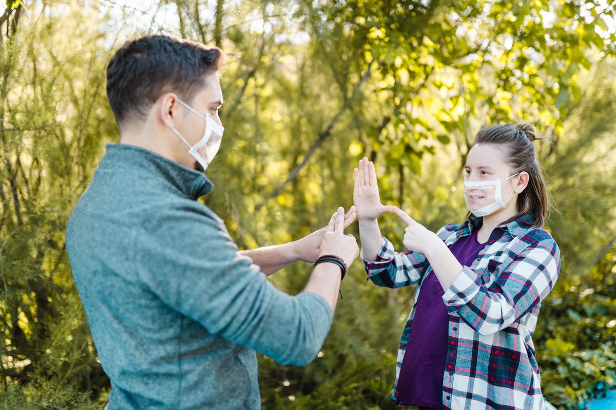 Deaf and hard hearing Young Adults wearing special face mask for lip-reading
