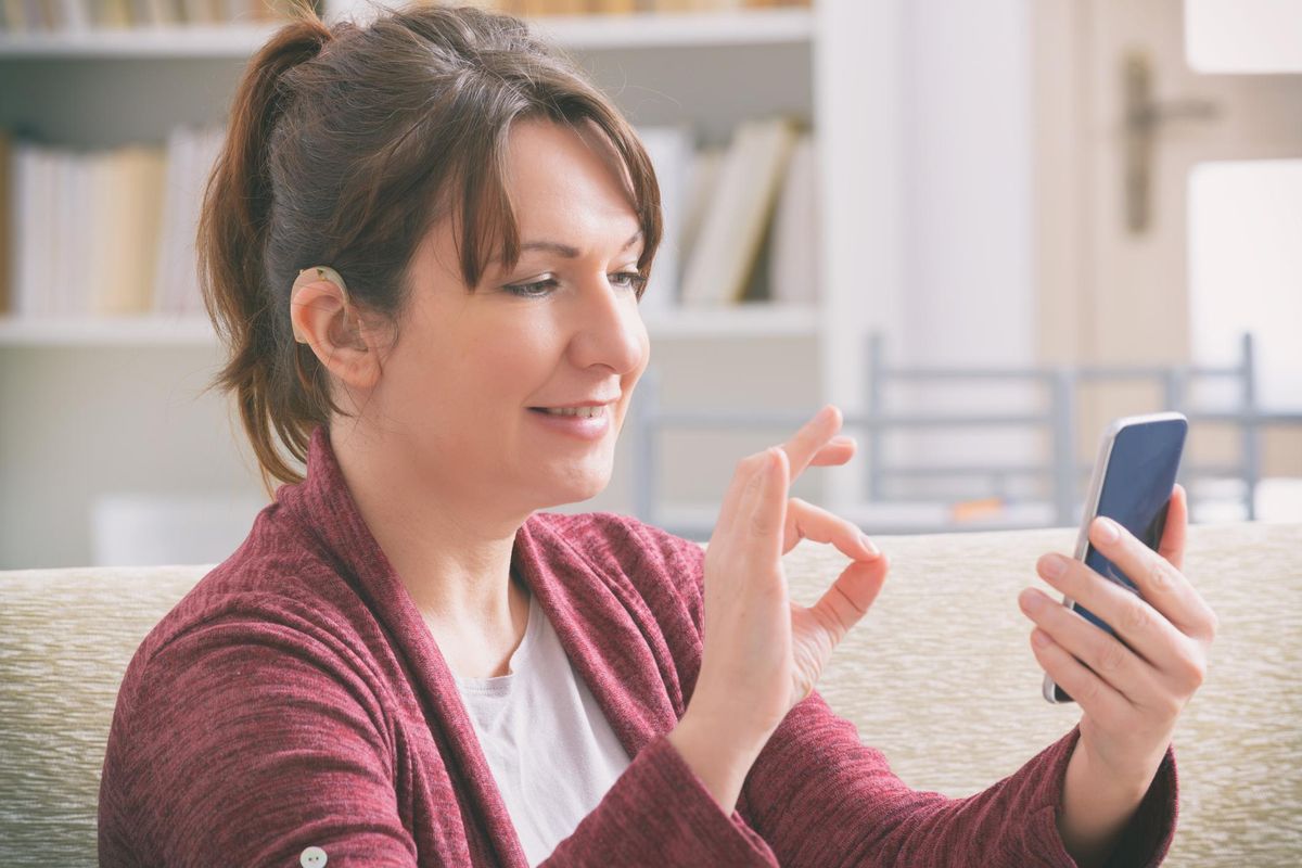 Deaf woman using smartphone