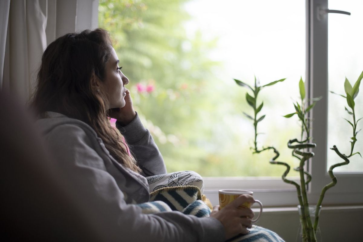 Depressed Woman Sitting by Window