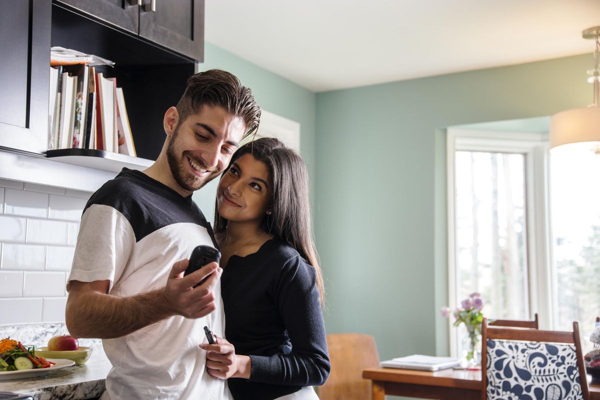 Diabetes patient checking his blood sugar levels with his partner