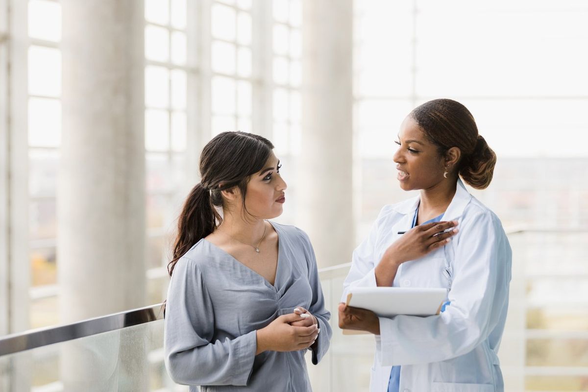 Doctor and young adult woman discuss test results