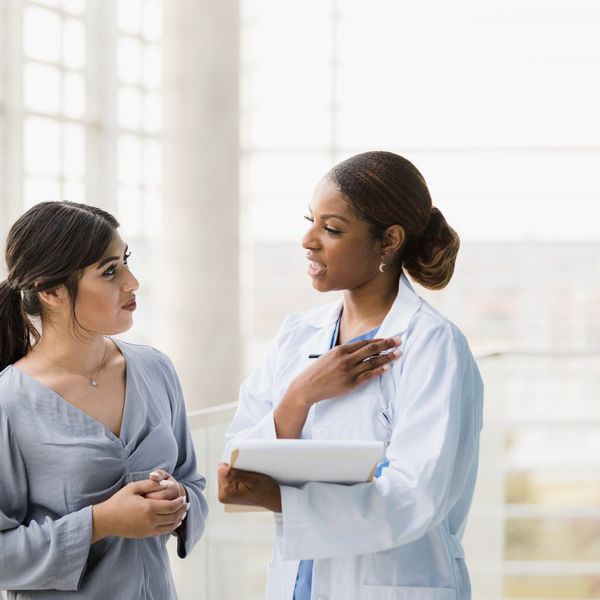 Doctor and young adult woman discuss test results