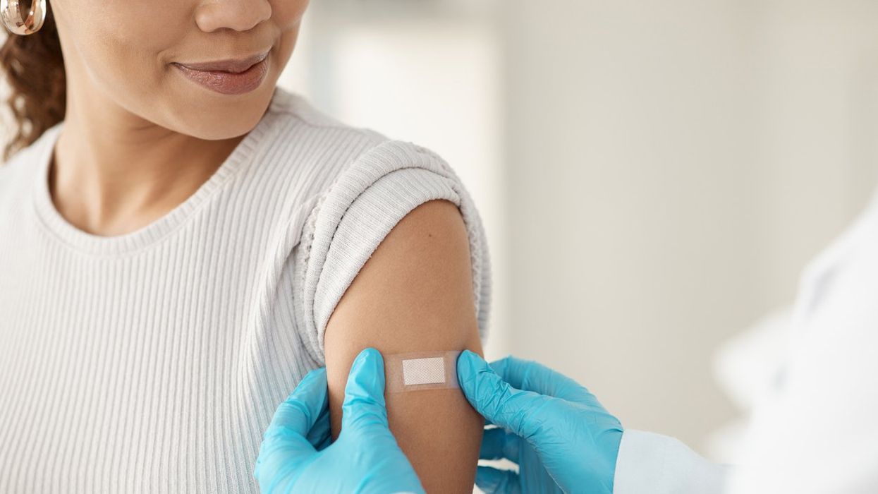 doctor applying a band-aid after getting a vaccination