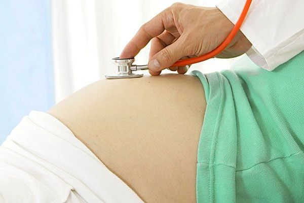 doctor checking pregnant woman