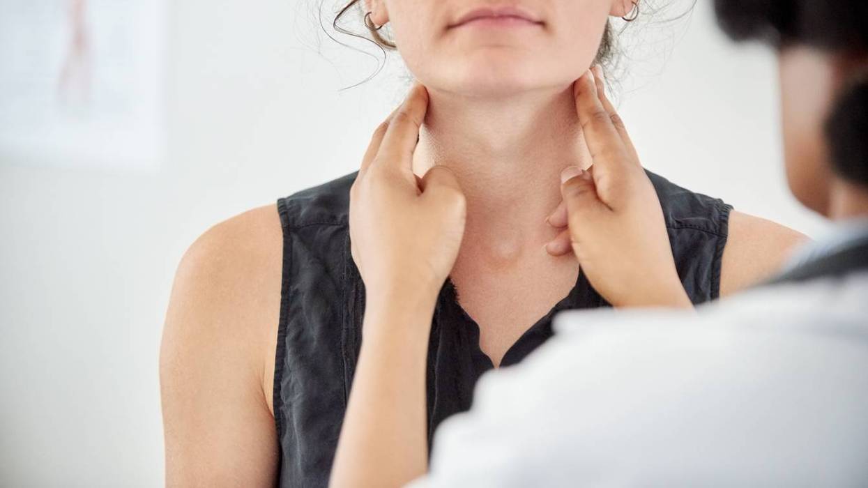 Doctor checking thyroid of a young patient