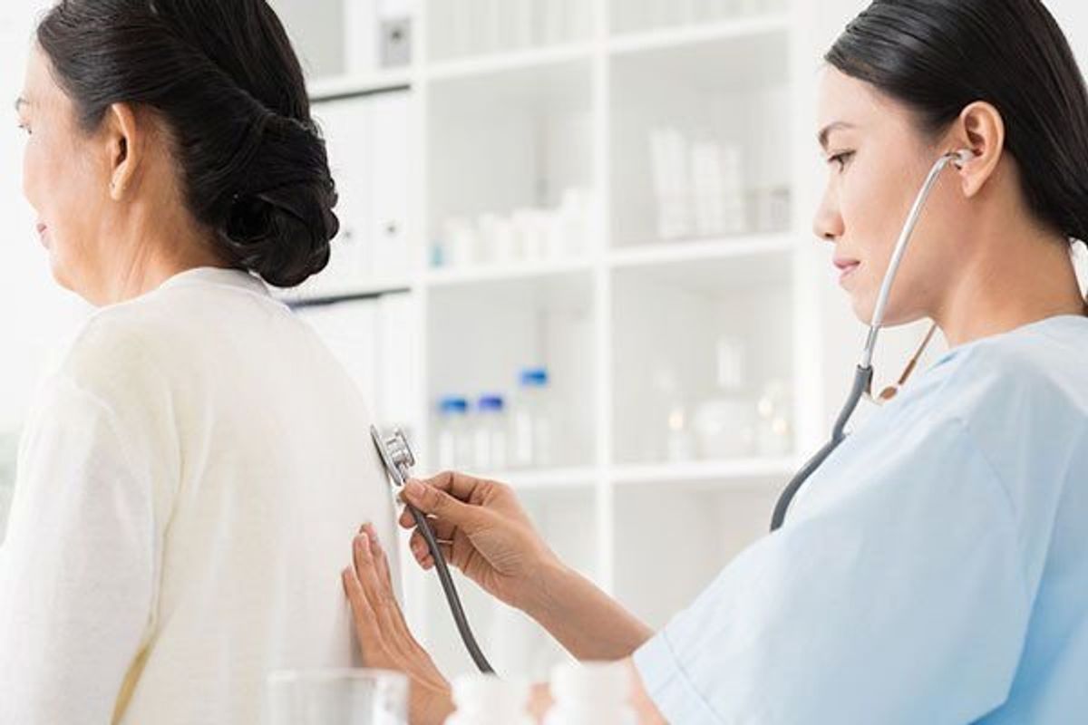 doctor checking woman's lung function