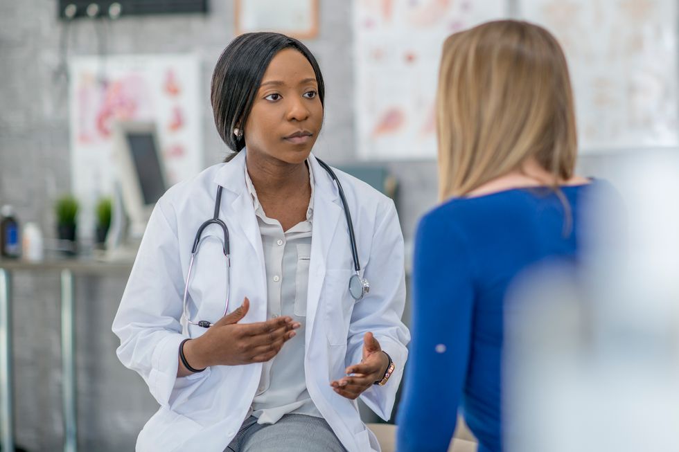 Doctor Comforting A Patient after a herpes diagnosis