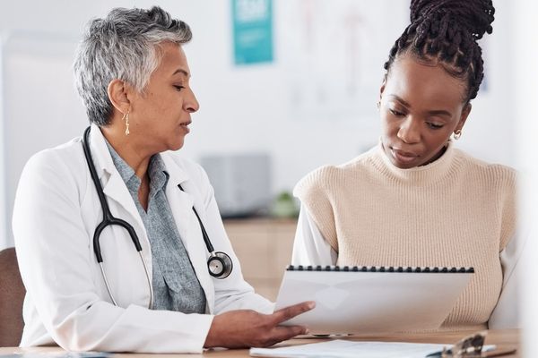 doctor consulting a patient in hospital for healthcare history or record