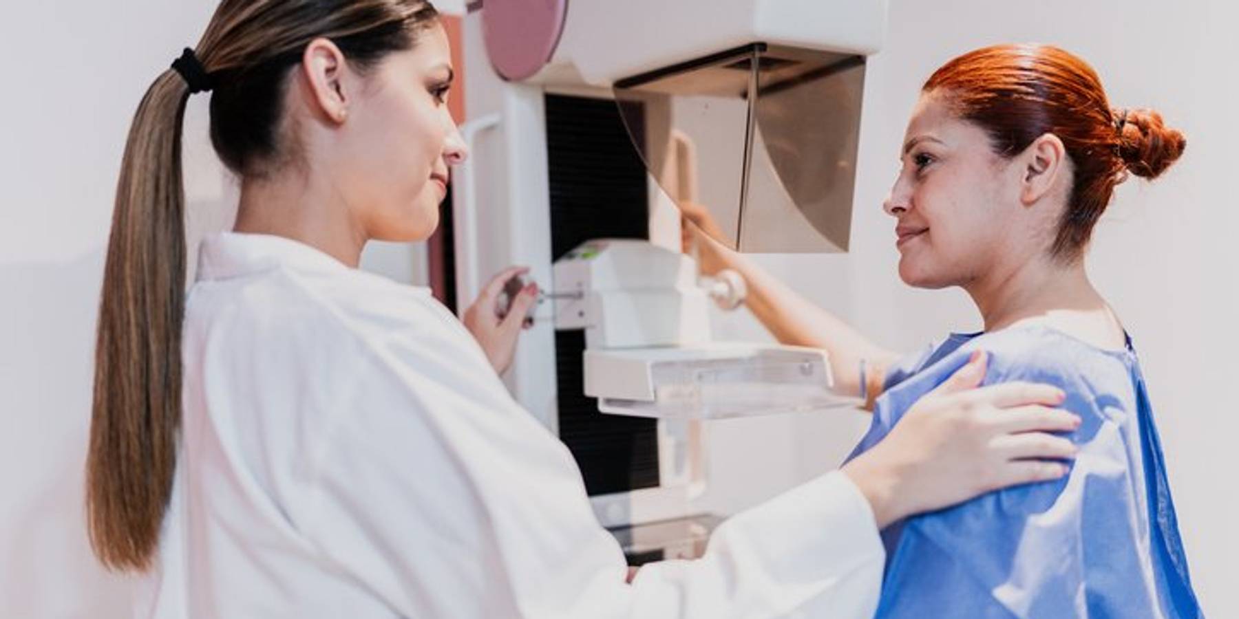 Doctor doing mammogram exam on patient at hospital. Mammograms are one way to detect DCIS.