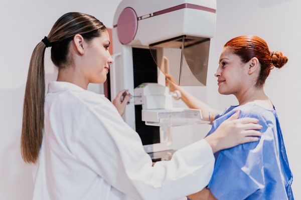 Doctor doing mammogram exam on patient at hospital. Mammograms are one way to detect DCIS.