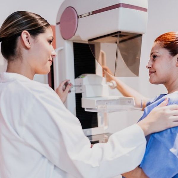 Doctor doing mammogram exam on patient at hospital. Mammograms are one way to detect DCIS.
