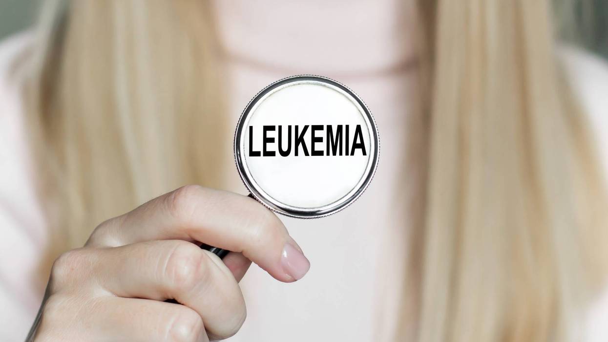Doctor holding stethoscope on which word LEUKEMIA
