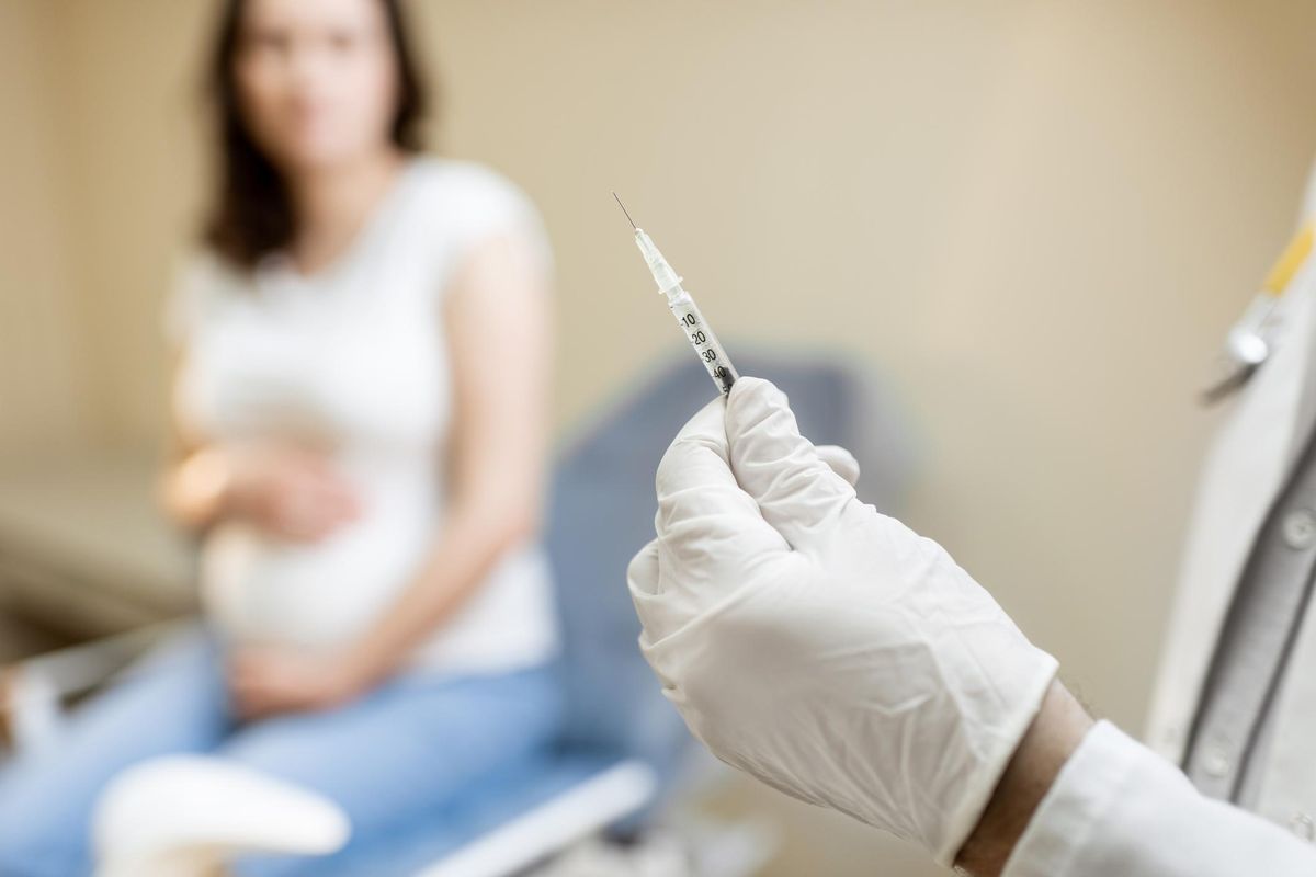 Doctor holding vaccine in the syringe