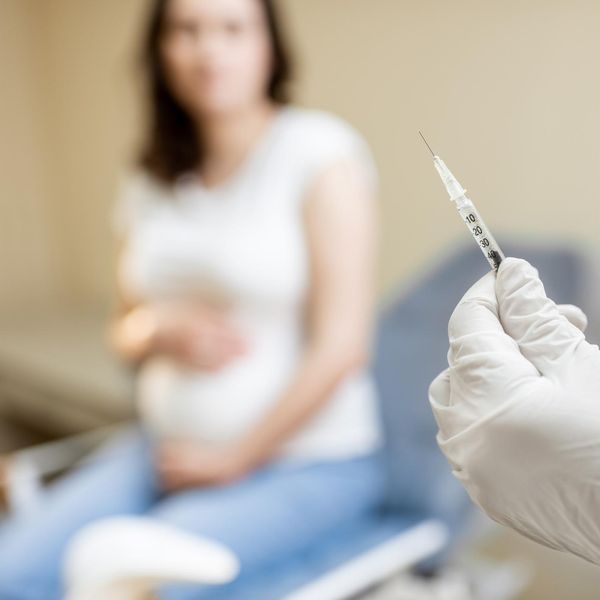 Doctor holding vaccine in the syringe