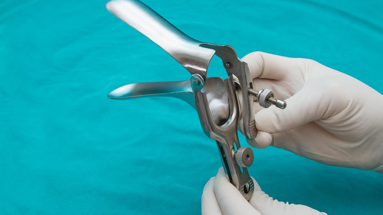 Doctor holds a disposable speculum