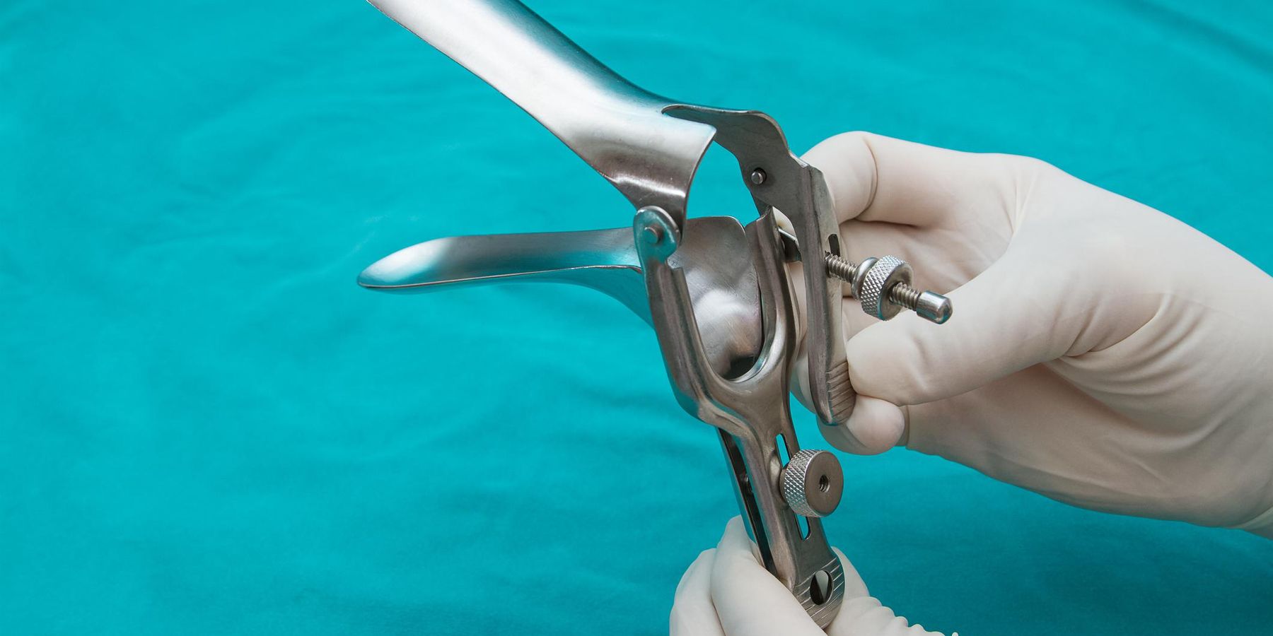 Doctor holds a disposable speculum