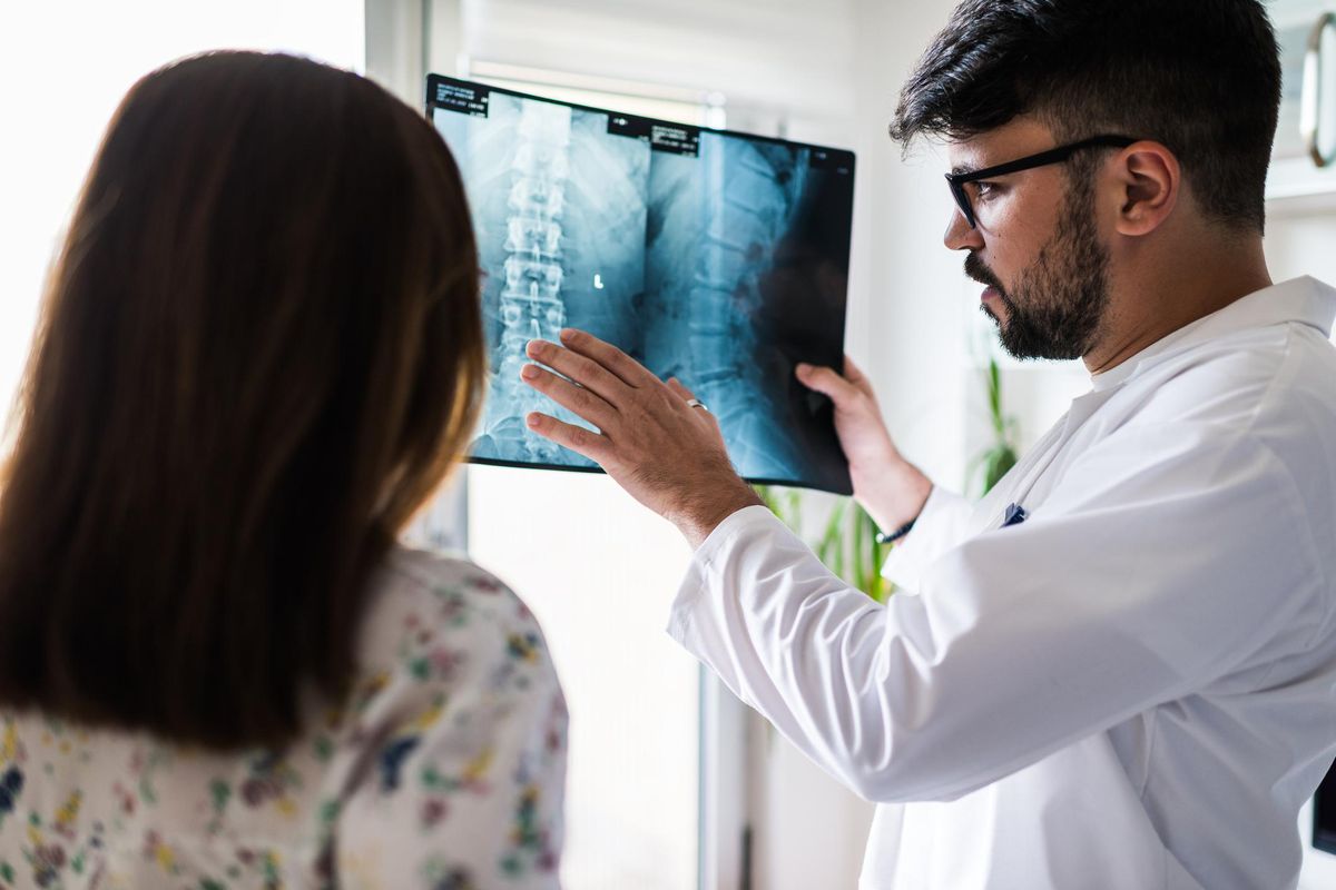 doctor looking at spinal xray