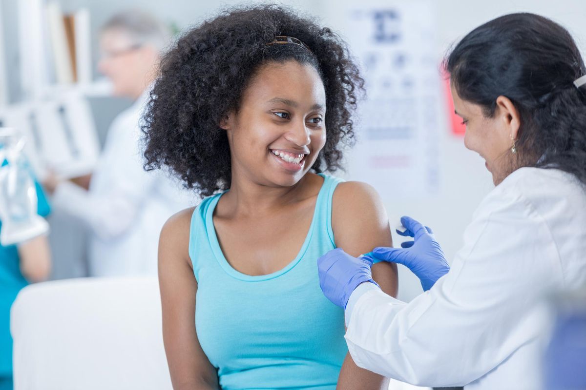 Doctor places bandage on patient's arm