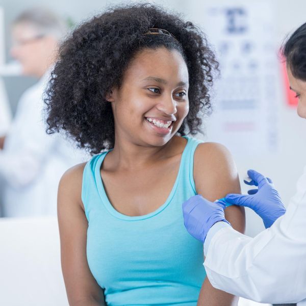 Doctor places bandage on patient's arm