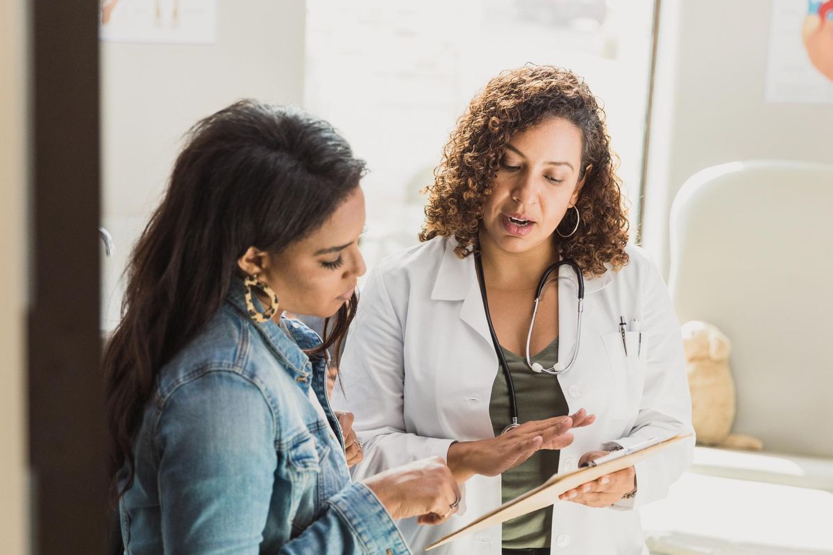 doctor talks with patient that has multiple sclerosis