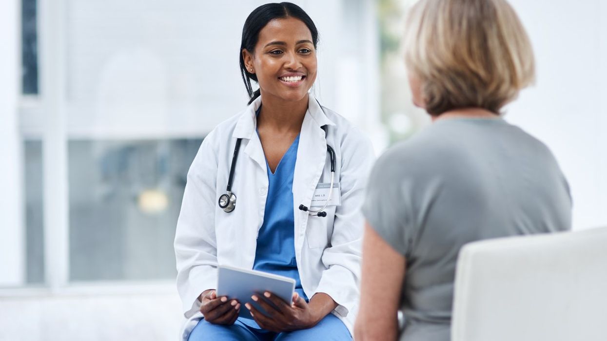 doctor using a digital tablet during a consultation with a senior woman