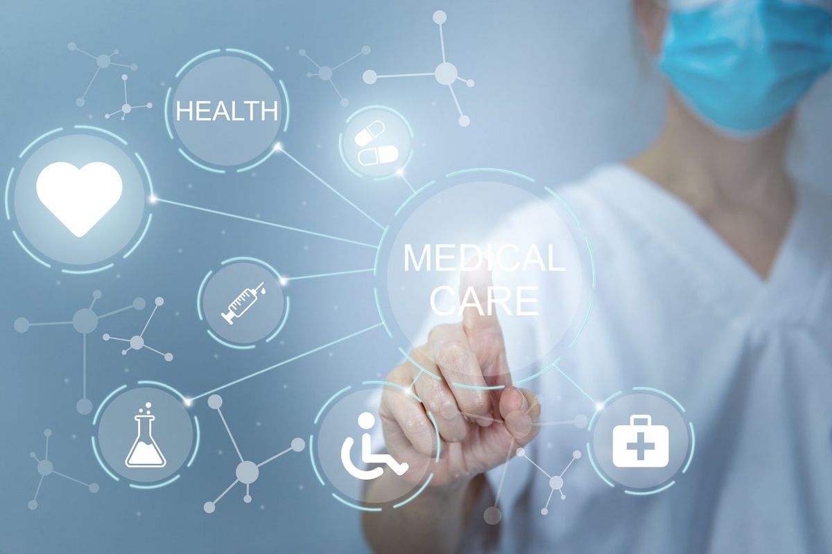 Doctor working on a virtual screen behind the structure of medical icons, medical care and health concept