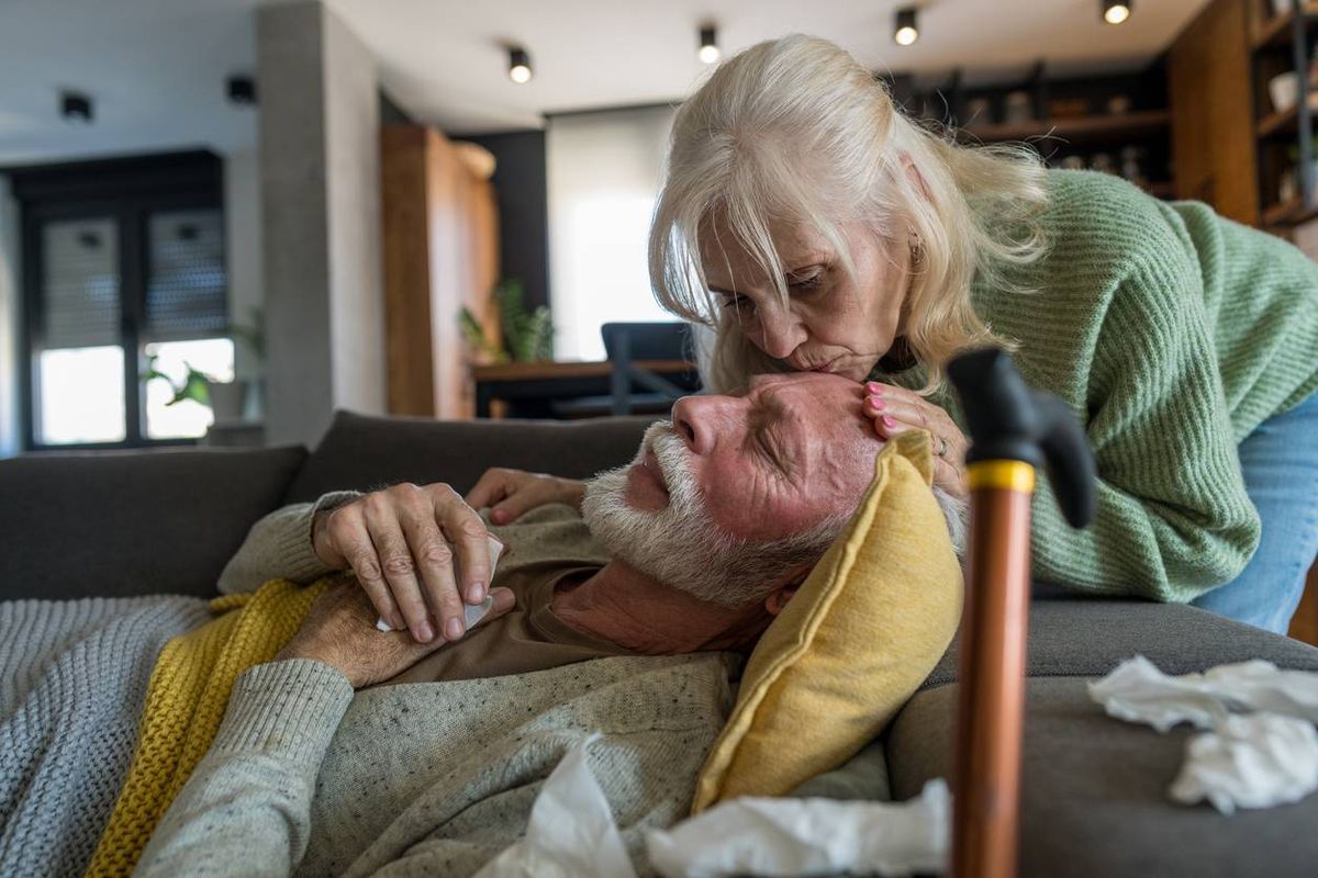 Elderly Woman Comforting Sick Husband at Home
