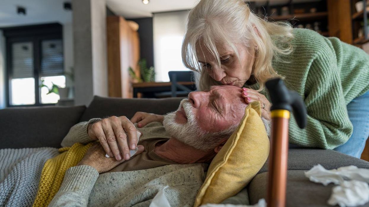 Elderly Woman Comforting Sick Husband at Home