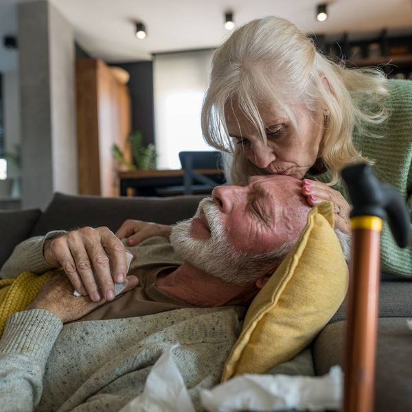 Elderly Woman Comforting Sick Husband at Home