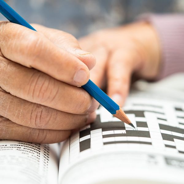 elderly woman playing sudoku puzzle game to practice brain training for dementia prevention
