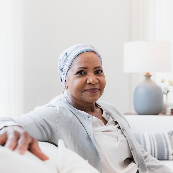 elderly woman poses for a portrait photo in her home.