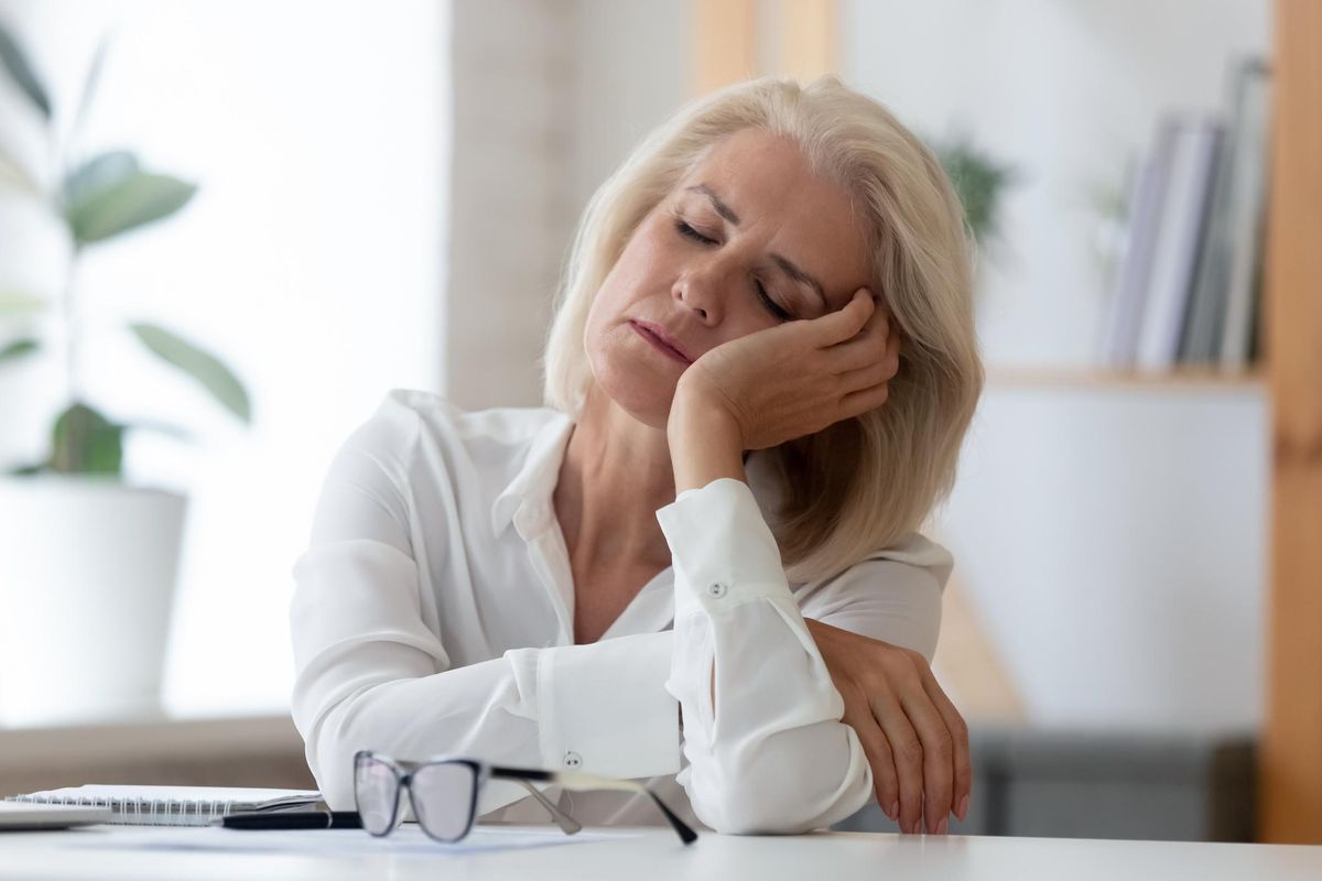 exhausted businesswoman fall asleep at workplace
