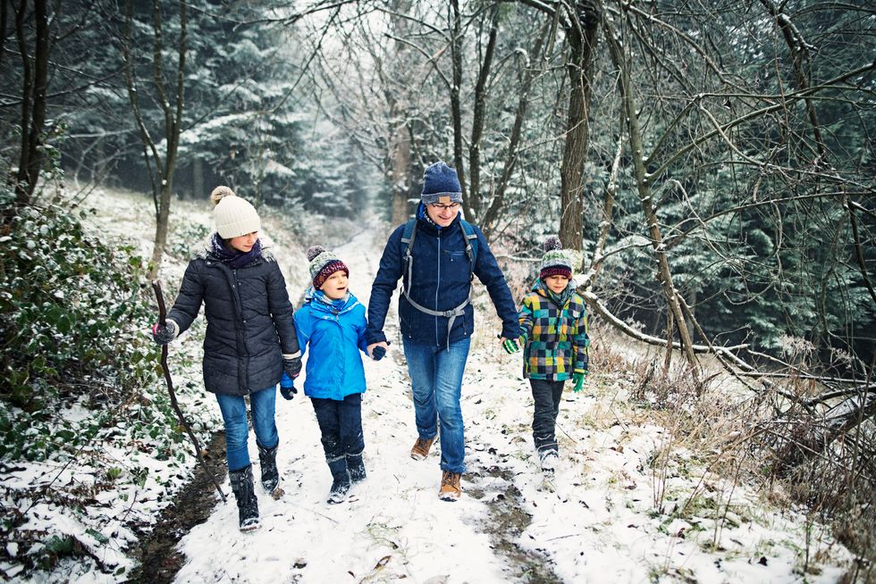 family walking in the snow